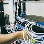 electronics engineer fixing cables on server