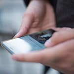 person using smartphone shallow focus photography