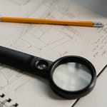So, how is the jobhunt going? black magnifying glass beside yellow pencil