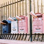 mailboxes on metal fence