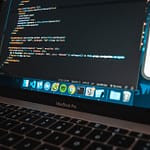 The hunt for a kernel bug, part 3: compiling a kernel workplace with modern laptop with program code on screen